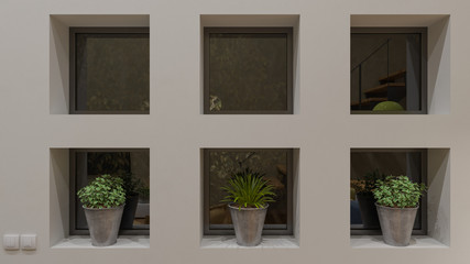 Fototapeta na wymiar Small Windows with Potted Plants in the Nighttime 3D Rendering