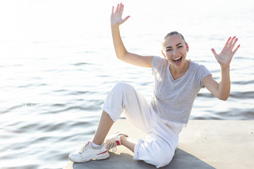 Fototapeta na wymiar Smiley woman posing next to lake