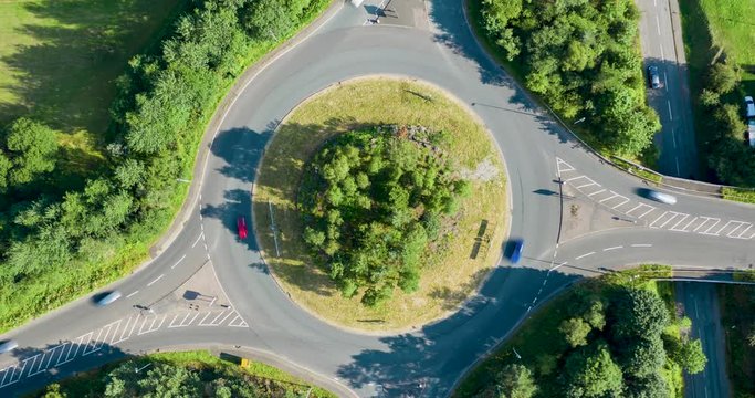 Aerial hyperlapse looking directly down onto a traffic roundabout with 4 junctions