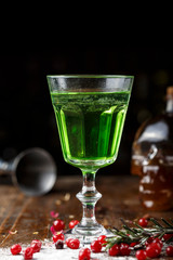 absinthe in a glass on the table