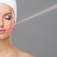 Doctor removing moles using laser ray. Beauty portrait of a young woman. Birthmark removal, plastic...