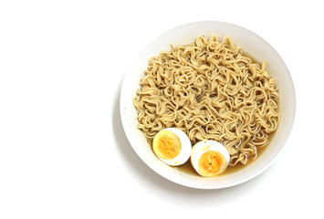 Instant noodles in white dish with boiled egg on white background.