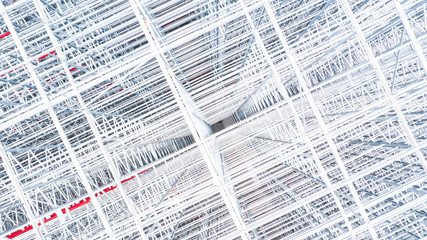 Obraz premium Aerial view structure of steel building construction, Metal steel frame buildings construction design, Aerial view construction site.