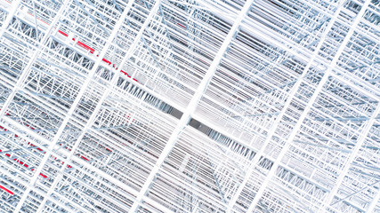 Obraz premium Aerial view structure of steel building construction, Metal steel frame buildings construction design, Aerial view construction site.
