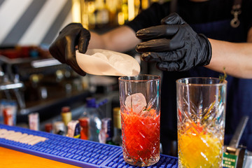barman make a cocktail in a restaurant