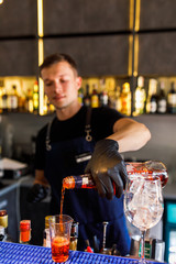 barman make a cocktail in a restaurant