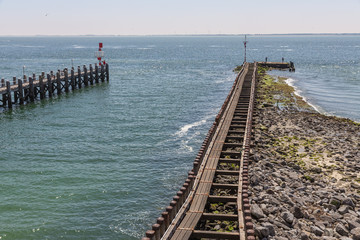 Fototapeta premium Entry Dutch harbor Vlissingen at Westerschelde with wooden jetty
