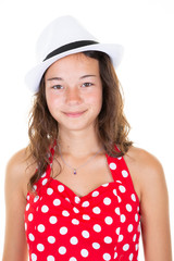 Portrait of a beautiful white red dress and hat teenager girl on a light background