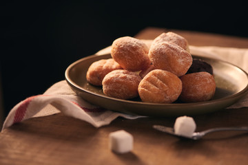 Small donuts with powdered sugar selective focus