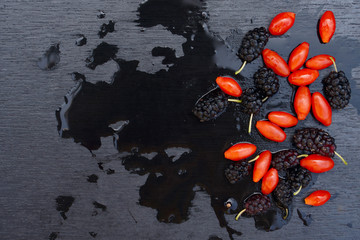 fresh berries of black mulberry and  red goji