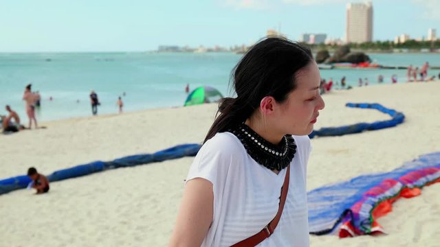 Woman standing on Araha Beach, Chatan, Okinawa Prefecture, Japan