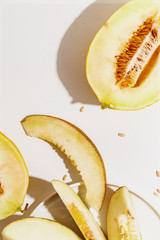 Sliced ripe juicy melon on a white background. Top view.
