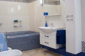 modern luxury bathroom with large bath tub and mosaic tiles