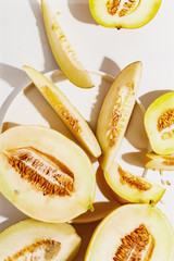 Sliced ripe juicy melon on a white background. Top view.