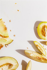Sliced ripe juicy melon on a white background. Top view.