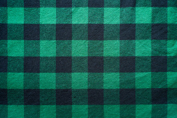 Fabric in a cage. Black and green square pattern. Clothes Empty Background