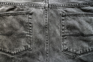 Gray jeans pockets. Texture of cotton fabric pants. Gray denim fabric