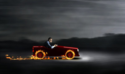 Businessman in a red car with flames