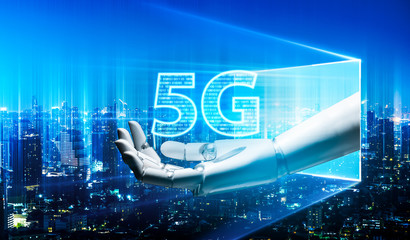 Robot android hand holding icon 5g.5G network digital hologram and internet of things on city background.5G network wireless systems.robot android hand holding icon 5g.