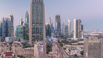 Skyline view of the buildings of Sheikh Zayed Road and DIFC day to night timelapse in Dubai, UAE.