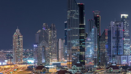 Fototapeta na wymiar Aerial view of illuminated skyscrapers and road junction in Dubai timelapse