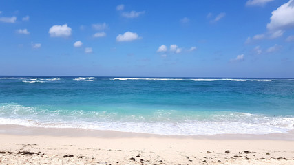 Fototapeta na wymiar Sandy beach with blue water in Bali, Indonesia
