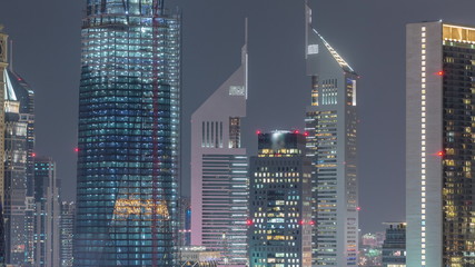 Aerial view on downtown and financial district in Dubai night timelapse, United Arab Emirates with skyscrapers and highways.