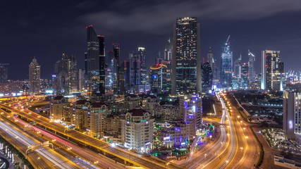 Obraz na płótnie Canvas Aerial view on downtown and financial district in Dubai during all night timelapse, United Arab Emirates with skyscrapers and highways.