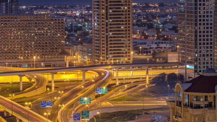 Fototapeta na wymiar Aerial view of highway interchange in Dubai downtown night to day timelapse.