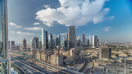 Naklejka na ściany i meble Skyline view of the buildings of Sheikh Zayed Road and DIFC timelapse in Dubai, UAE.