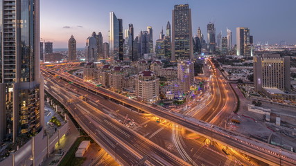 Skyline view of the buildings of Sheikh Zayed Road and DIFC day to night timelapse in Dubai, UAE.