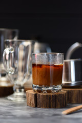 Coconut milk coffee Vietnamese style prepared in phin on dark background