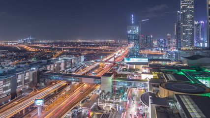 Obraz premium Aerial view of Financial center road night timelapse with under construction building