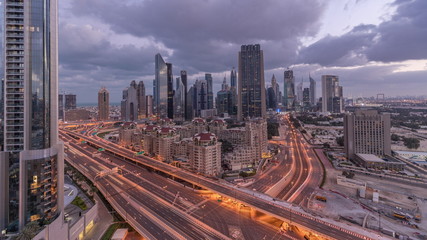 Fototapeta na wymiar Skyline view of the buildings of Sheikh Zayed Road and DIFC night to day timelapse in Dubai, UAE.
