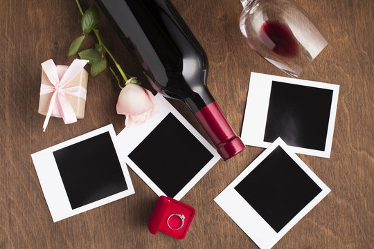 Flat lay arrangement with wine and photos