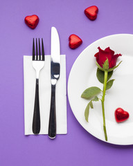 Fototapeta na wymiar Flat lay romantic table setting with red rose