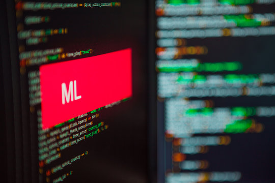 Programming language, ML inscription on the background of computer code.