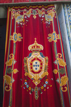 a curtain in a church with an emblem of Portugal