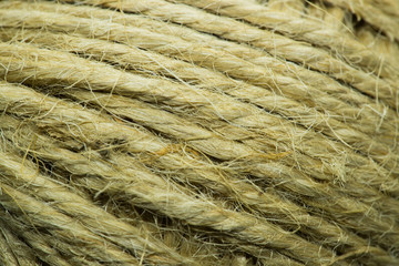 Close-up macro view of twine or string from natural fabric wrapped in a ball.