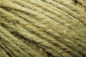 Close-up macro view of twine or string from natural fabric wrapped in a ball.