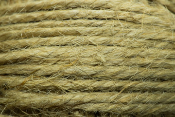 Close-up macro view of twine or string from natural fabric wrapped in a ball.