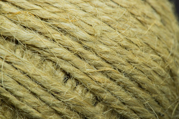 Close-up macro view of twine or string from natural fabric wrapped in a ball.