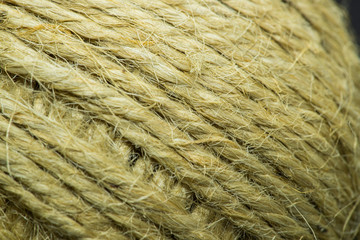 Close-up macro view of twine or string from natural fabric wrapped in a ball.