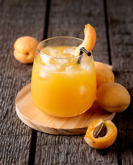 Glass of Fresh Tasty Apricot Juice on the Wooden Background Vertical Healthy Diet Drink