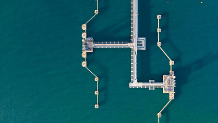 Aerial view crude oil and gas terminal, Loading arm oil and gas refinery at commercial port.