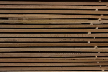 Background of a stack of wooden boards in storage