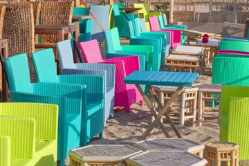 Summer terrace cafe, colorful multi colored chairs and tables outside. Concept food