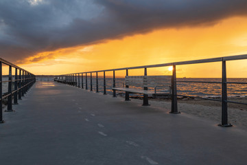 Fototapeta premium Dramatic summer sunset over sea. Scenic landscape with pier on the sea during beautiful sunset. Sweden