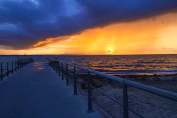 Dramatic summer sunset over sea. Scenic landscape with pier on the sea during beautiful sunset. Sweden