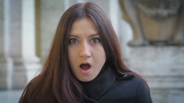 young brunette woman making astonished face at the camera.shock, surprise